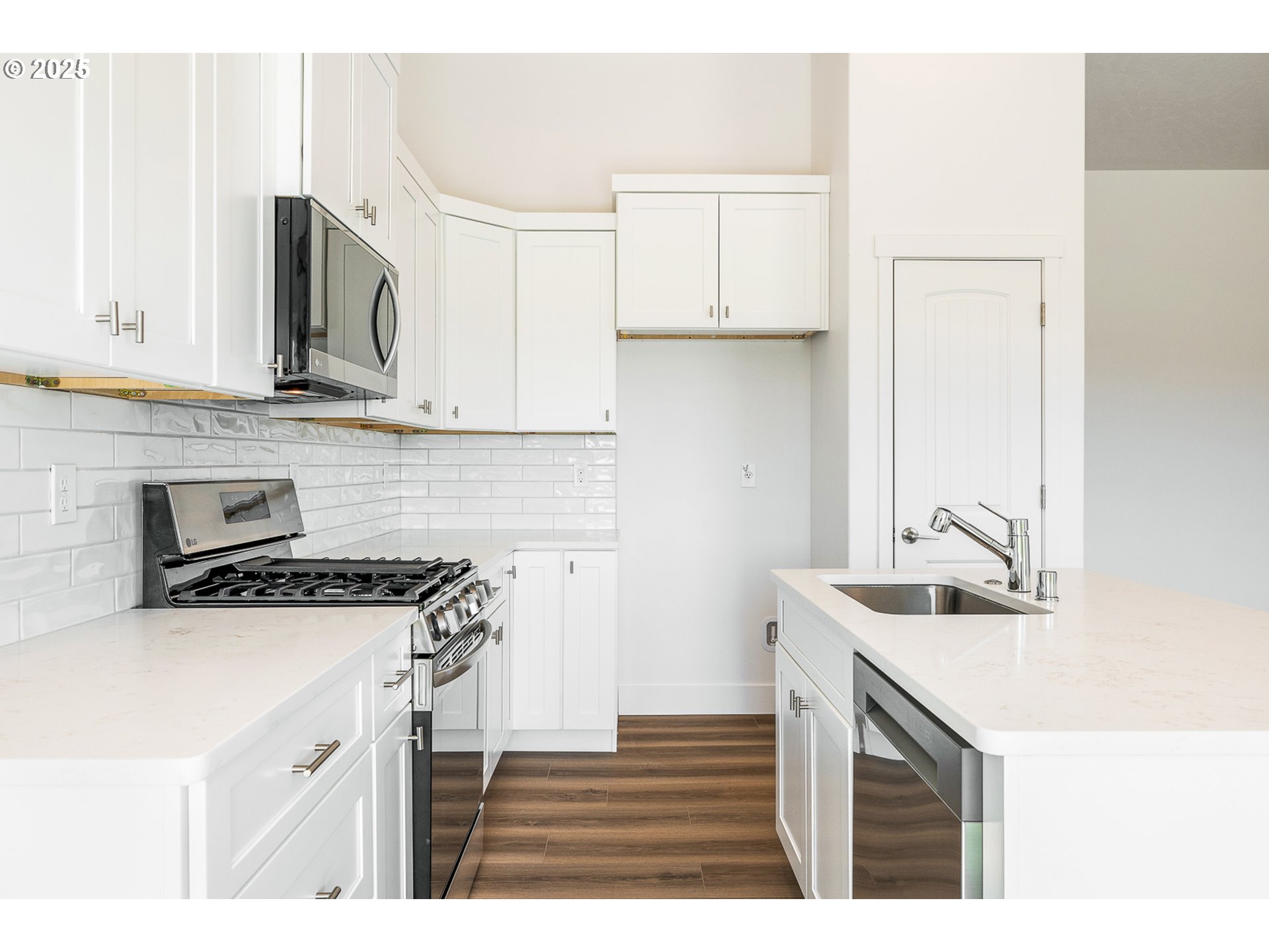 303 Sage Street Boardman, OR 97818 - Photo 15 of 25 a kitchen with kitchen island a sink stove top oven and microwave
