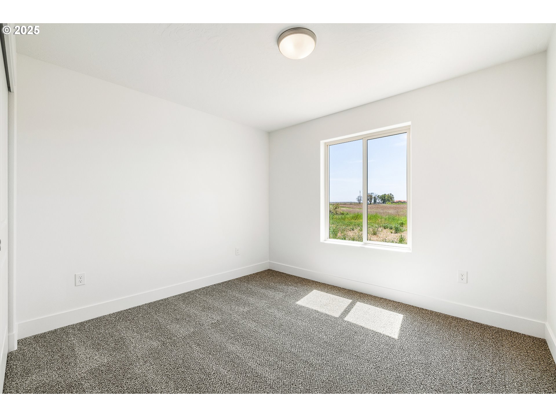 303 Sage Street Boardman, OR 97818 - Photo 19 of 25 a view of an empty room with a window