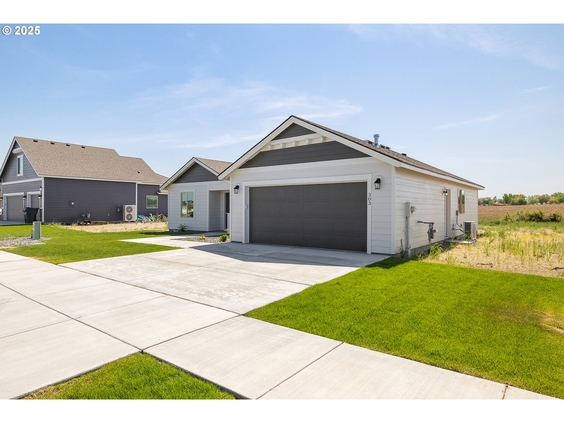 303 Sage Street Boardman, OR 97818 - Photo 20 of 25 a front view of a house with a yard and garage