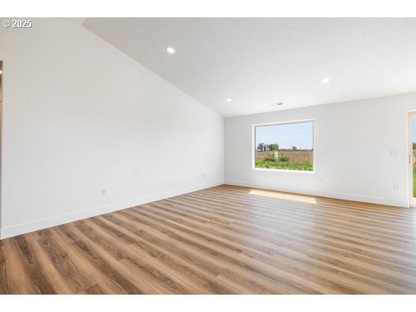 303 Sage Street Boardman, OR 97818 - Photo 8 of 25 a view of an empty room with wooden floor and a window