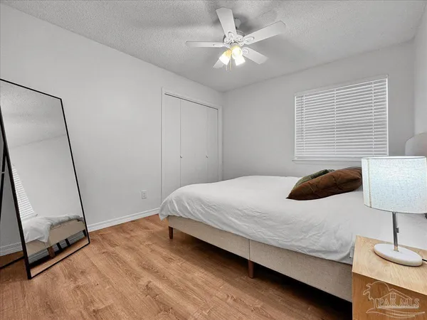 a bedroom with a bed and a mirror