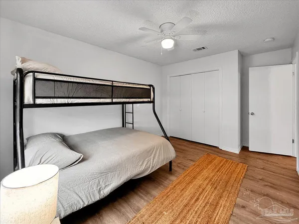 a bedroom with a bed and a night stand