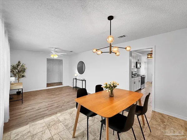 a view of a dining room and a table & chairs