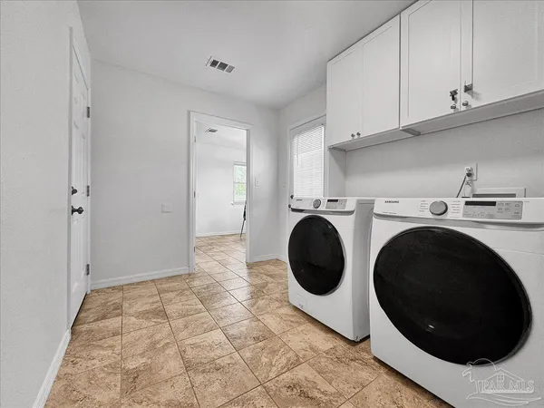 a view of a storage & utility room with a washer dryer