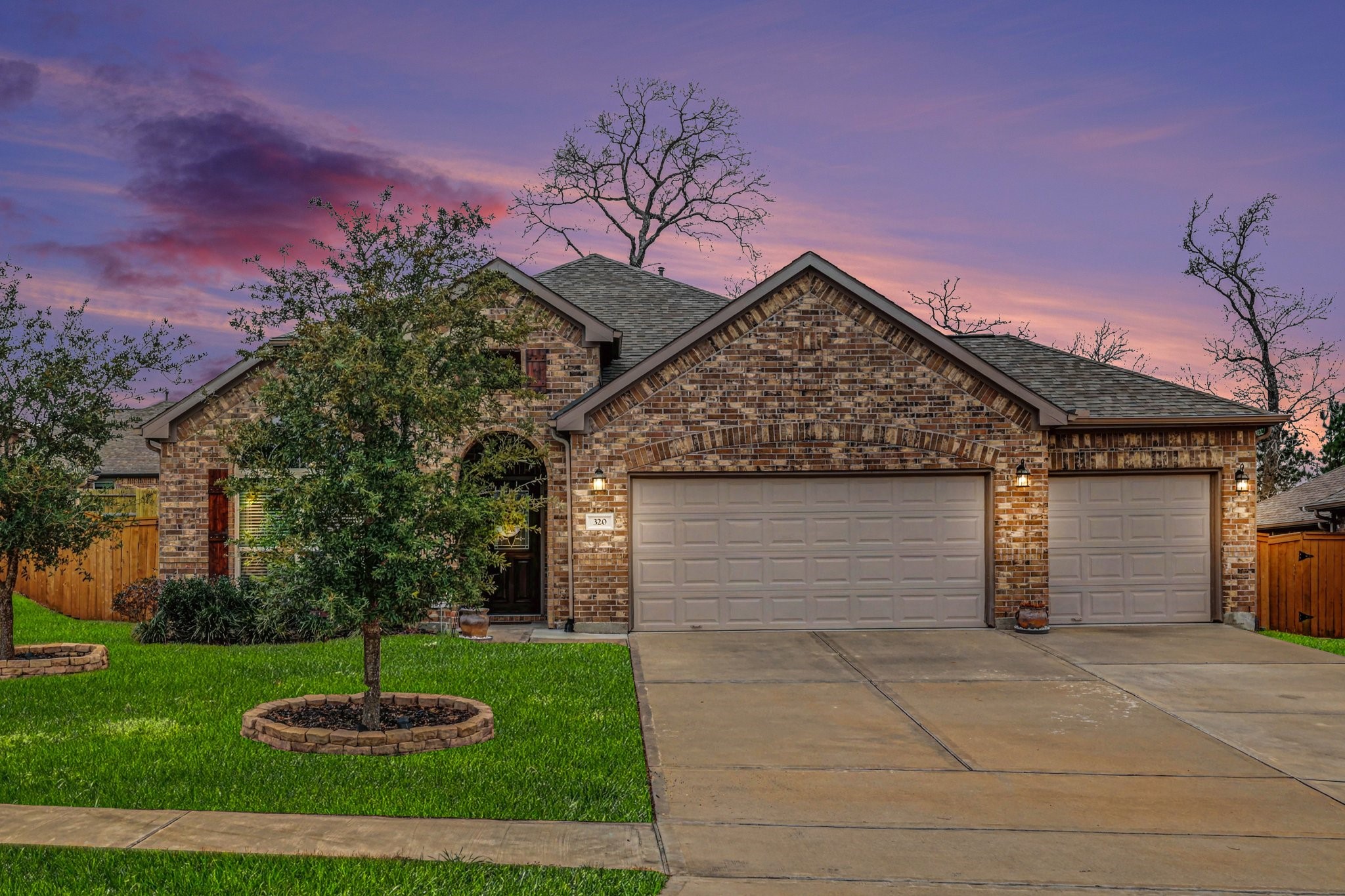 320 Red Maple Lane Conroe, TX 77304 - Photo 22 of 24 Elegant multi-tone brick exterior.