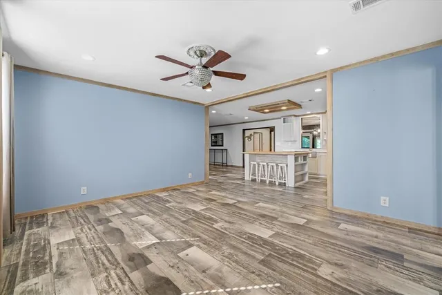 a view of a livingroom with wooden floor and a window