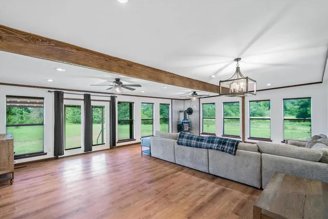 a living room with furniture and large windows