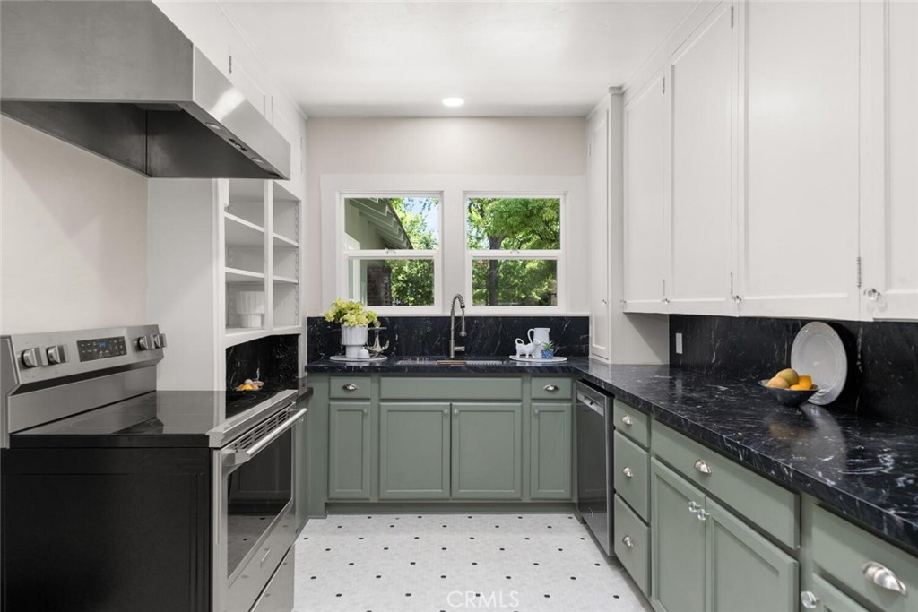 1336 Chestnut Street Chico, CA 95928 - Photo 13 of 41 a kitchen with stainless steel appliances a sink stove and cabinets