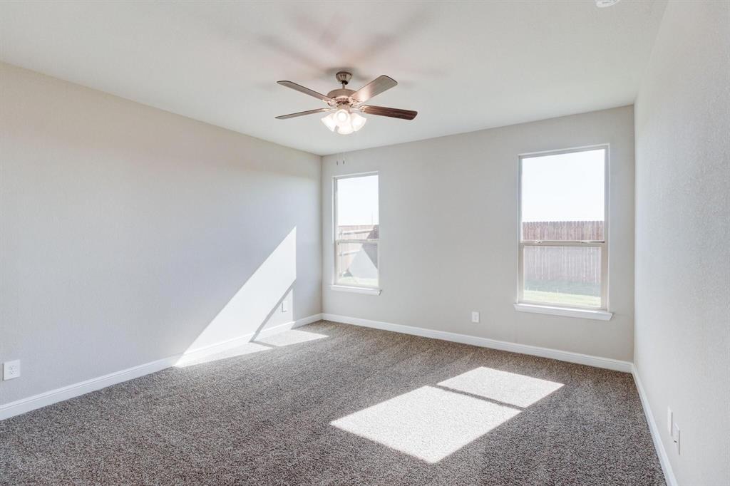 15524 Balham Pass Fort Worth, TX 76247 - Photo 5 of 10 a view of an empty room with window and chandelier fan