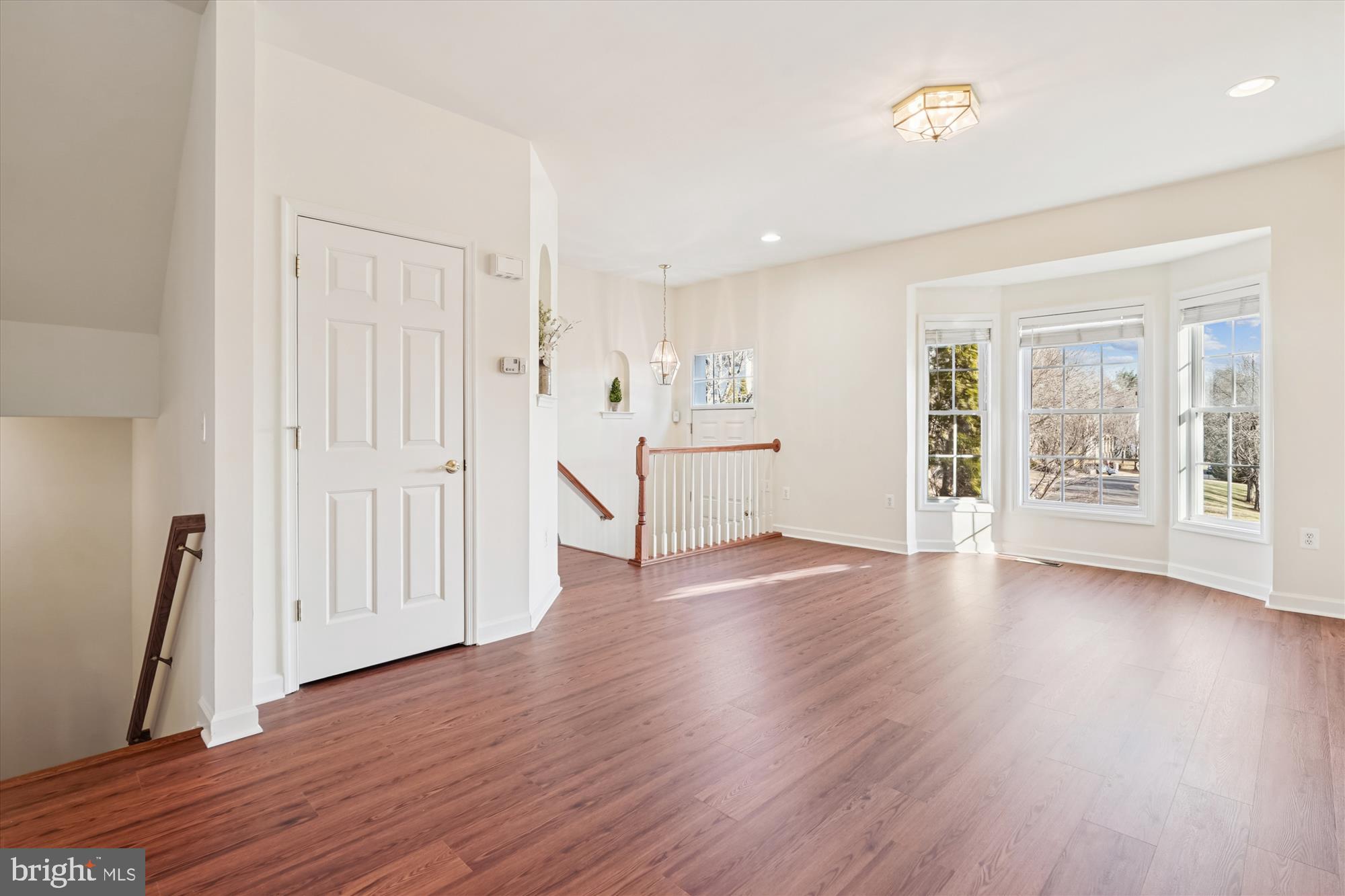 796 Col Edmonds Court Warrenton, VA 20186 - Photo 17 of 47 an empty room with wooden floor and windows