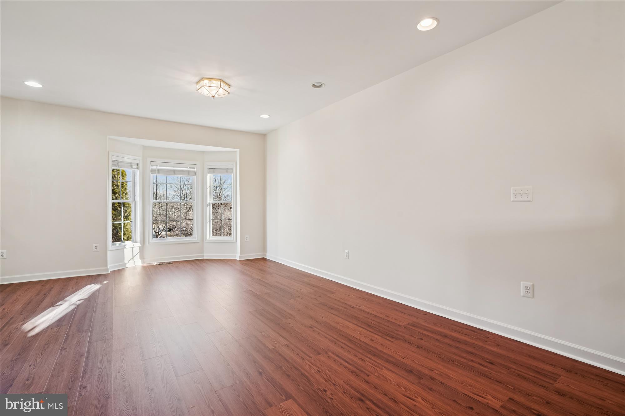 796 Col Edmonds Court Warrenton, VA 20186 - Photo 18 of 47 a view of an empty room with wooden floor and a window