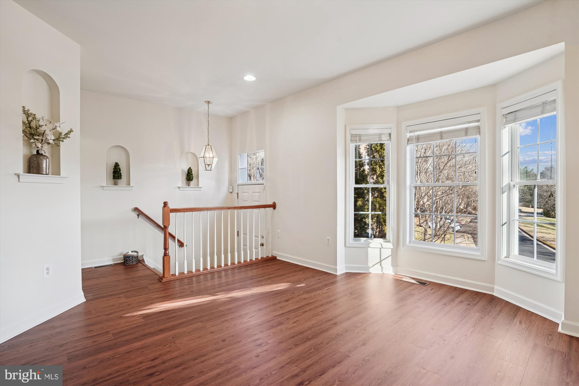 796 Col Edmonds Court Warrenton, VA 20186 - Photo 3 of 47 a view of an empty room with wooden floor and a window