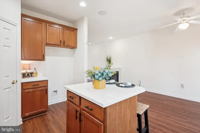 a kitchen with a sink appliances and wooden floor