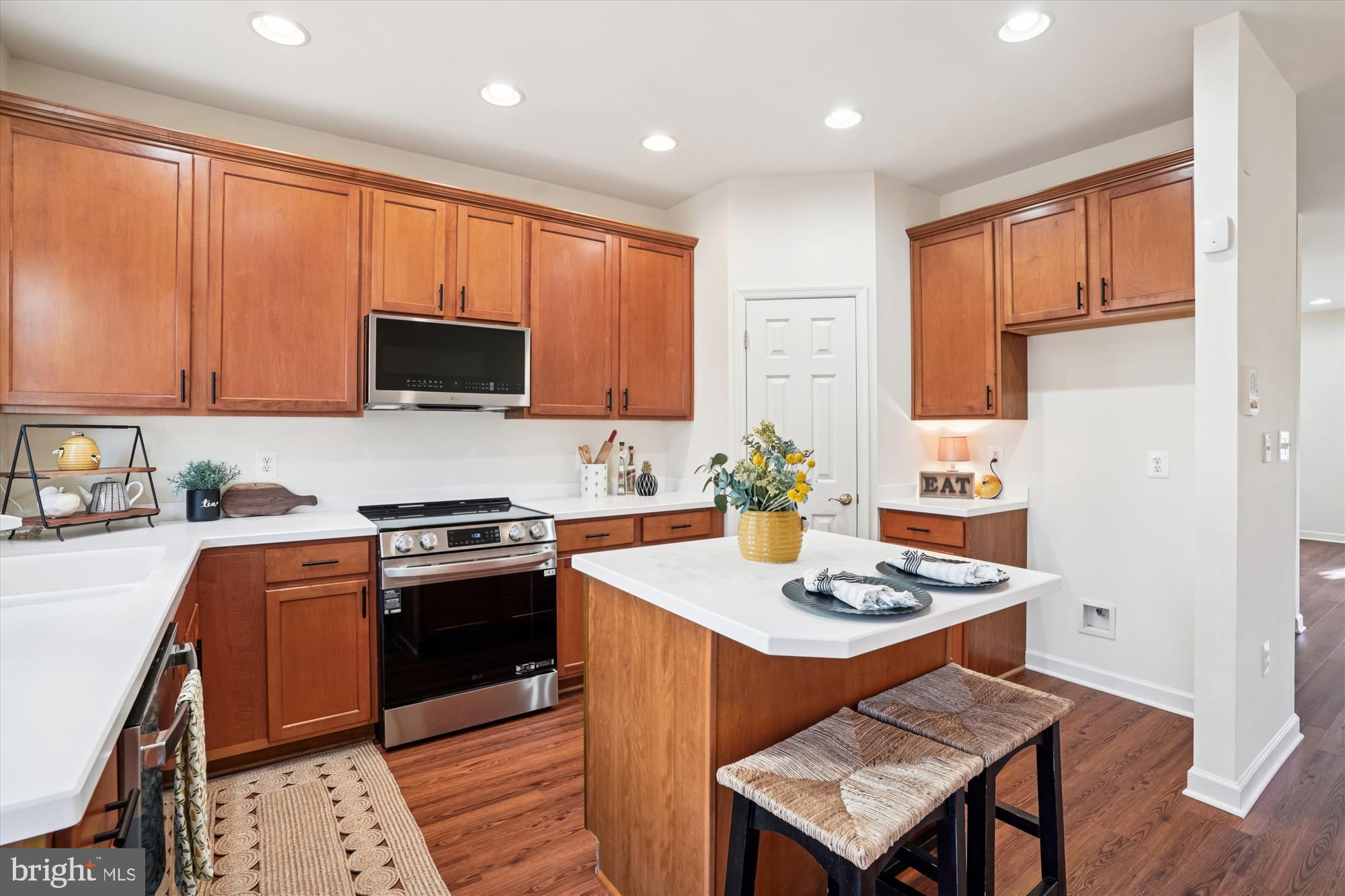 796 Col Edmonds Court Warrenton, VA 20186 - Photo 7 of 47 a kitchen with stainless steel appliances granite countertop a stove top oven a sink dishwasher and a refrigerator with wooden floor