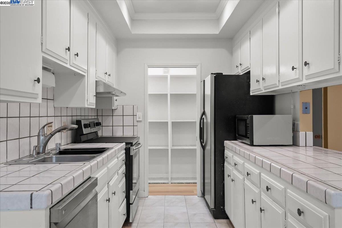 1043 Bonner Avenue Fremont, CA 94536 - Photo 4 of 16 a kitchen with granite countertop a sink and a refrigerator