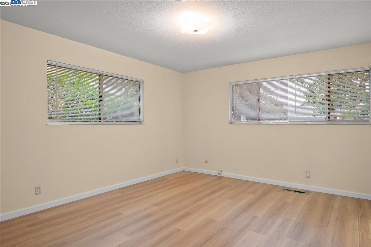 1043 Bonner Avenue Fremont, CA 94536 - Photo 7 of 16 a view of empty room with wooden floor and fan
