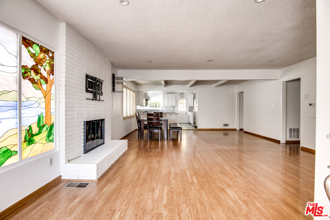 8204 Pershing Drive Playa del Rey, CA 90293 - Photo 3 of 20 a view of a livingroom with furniture a fireplace and wooden floor