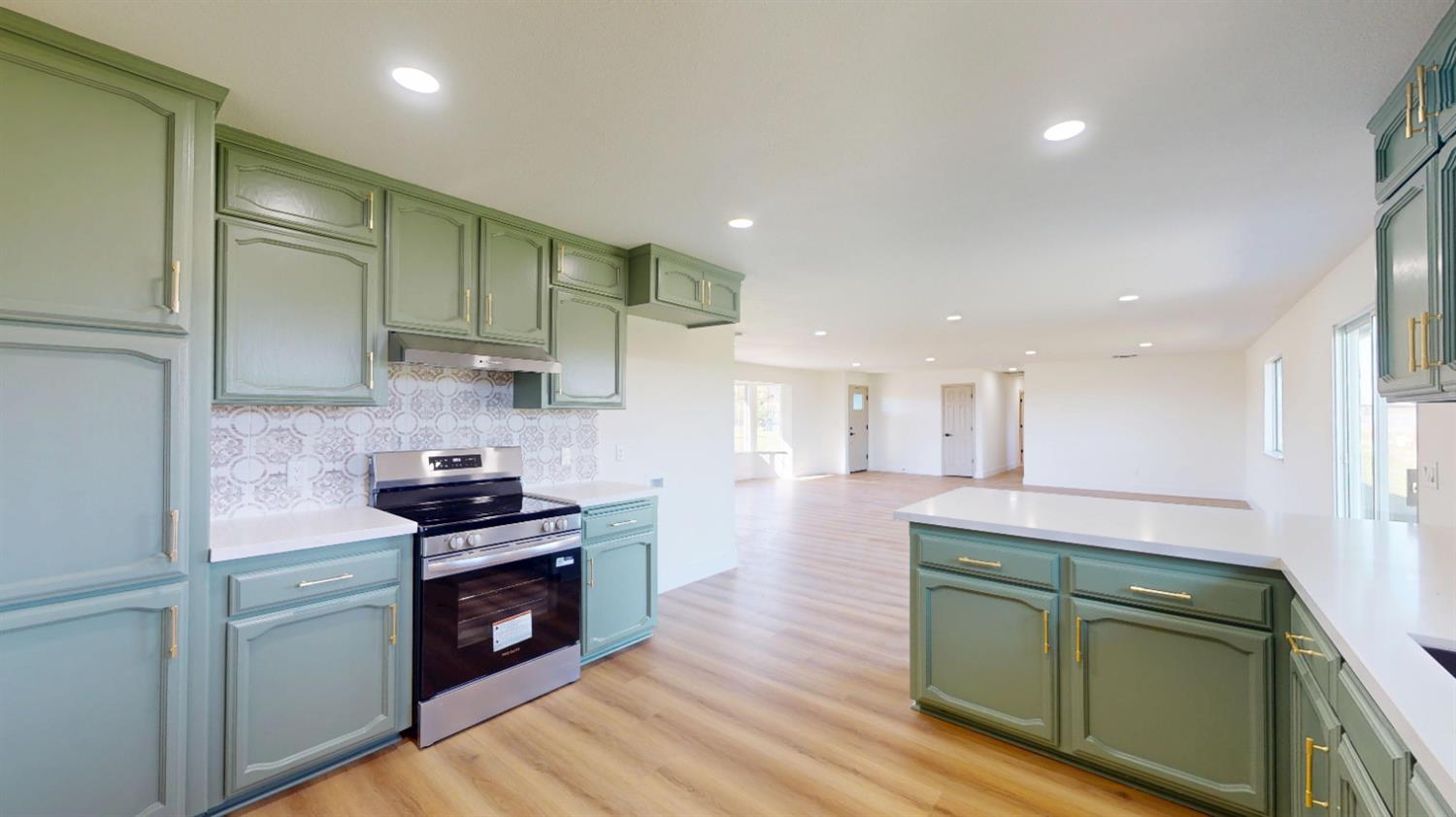 16363 Paula Road Madera, CA 93636 - Photo 4 of 29 a kitchen with stainless steel appliances granite countertop a stove a sink and a refrigerator
