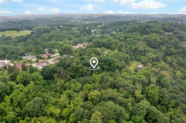 an aerial view of a houses with a yard