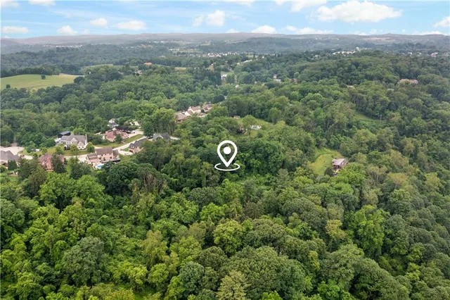 an aerial view of a houses with a yard