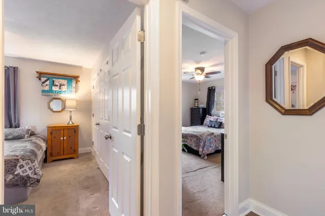 a en suite bathroom with a tub shower and a mirror