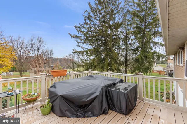a view of a deck with wooden floor and outdoor seating
