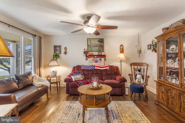 a living room with patio a couch and a chandelier