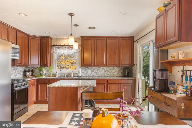a kitchen with a stove a sink and a refrigerator