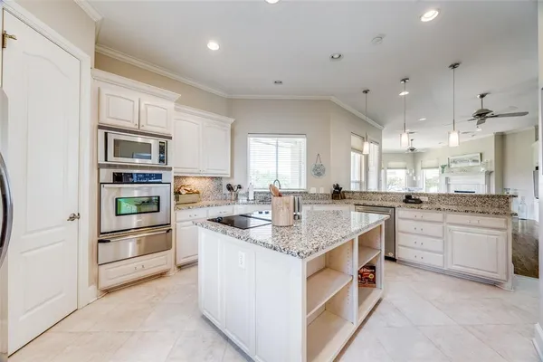 a kitchen with stainless steel appliances granite countertop a sink and cabinets