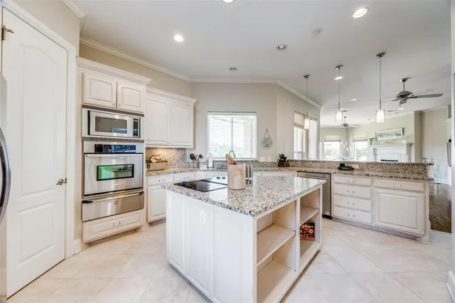a kitchen with stainless steel appliances granite countertop a sink and cabinets
