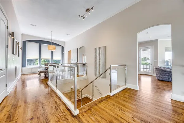 a very nice looking living room with a large window and wooden floor