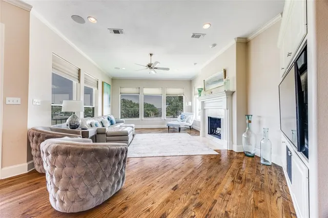 a living room with fireplace furniture and a large window