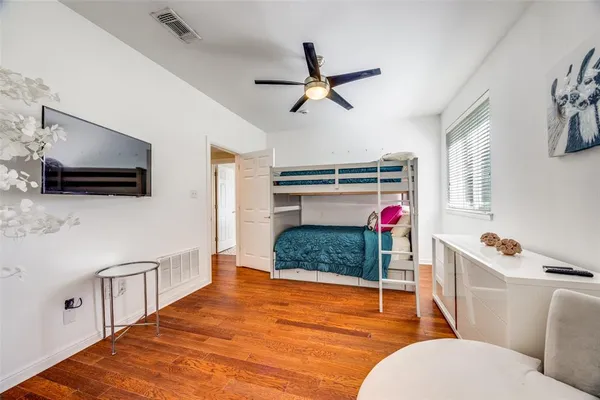 a bedroom with a bed and flat screen tv
