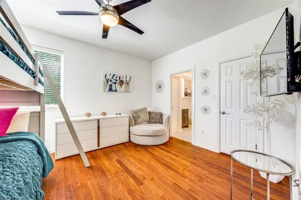 a bedroom with a bed and wooden floor