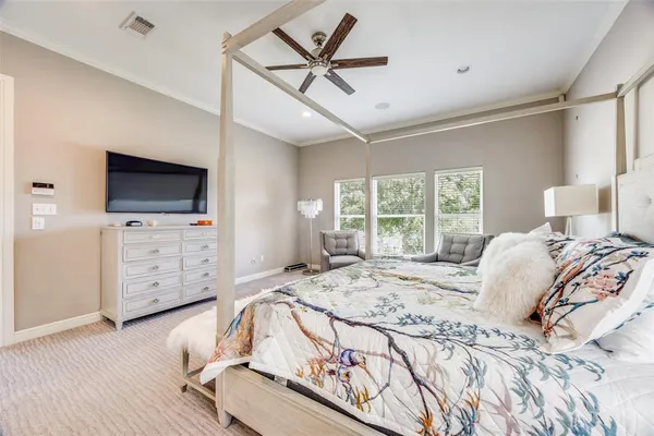 a bed sitting in a spacious bedroom next to a window