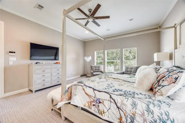 a bed sitting in a spacious bedroom next to a window