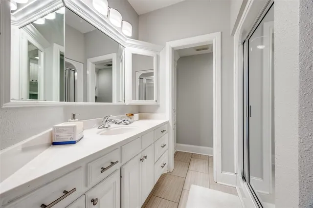 a bathroom with a double vanity sink and mirror