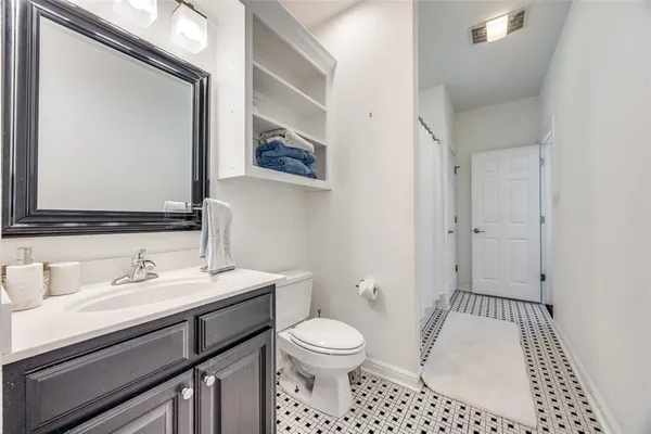 a bathroom with a sink a toilet a mirror and shower