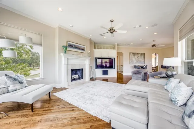 a living room with furniture fireplace and a large window
