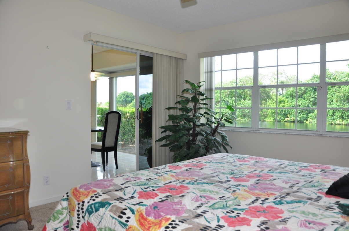 17288 Boca Club Boulevard, Unit 2001 Boca Raton, FL 33487 - Photo 14 of 25 a bedroom with a bed and a window