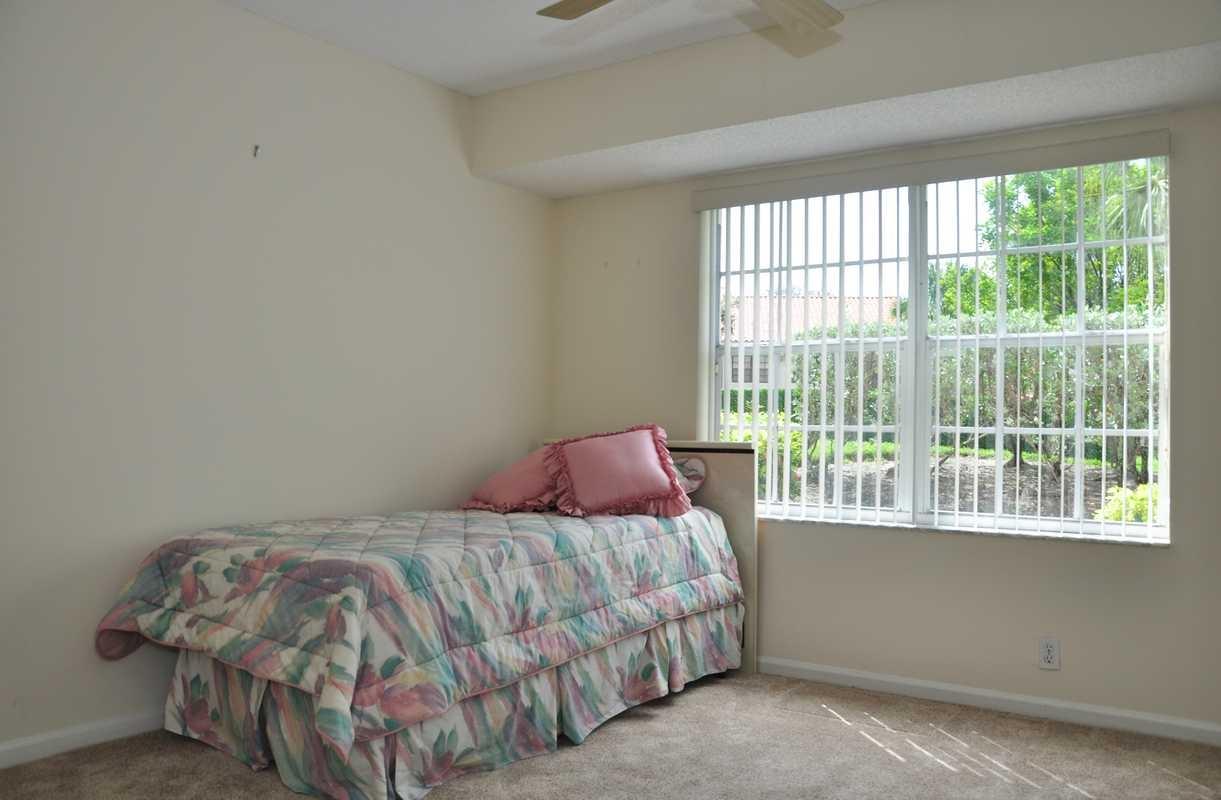 17288 Boca Club Boulevard, Unit 2001 Boca Raton, FL 33487 - Photo 18 of 25 a bedroom with a bed and a window