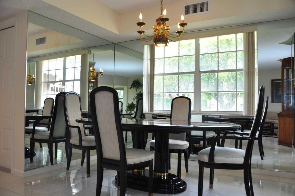 17288 Boca Club Boulevard, Unit 2001 Boca Raton, FL 33487 - Photo 10 of 25 a view of a dining room with furniture and window