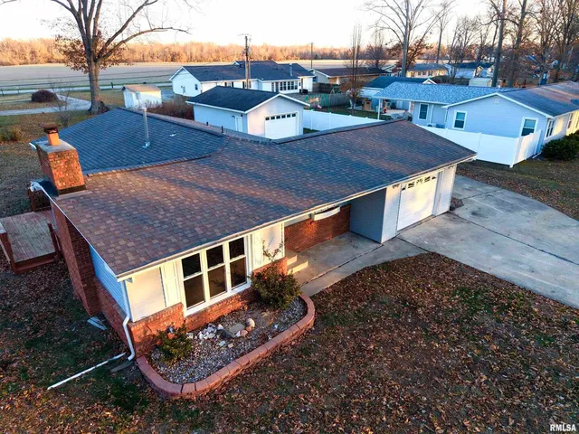 a large kitchen with stainless steel appliances wooden floor and wooden cabinets