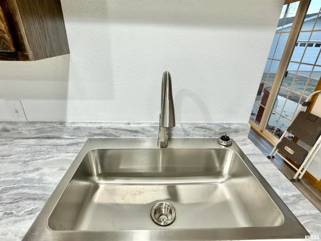 a kitchen with stainless steel appliances granite countertop wooden cabinets a sink and dishwasher a stove top oven