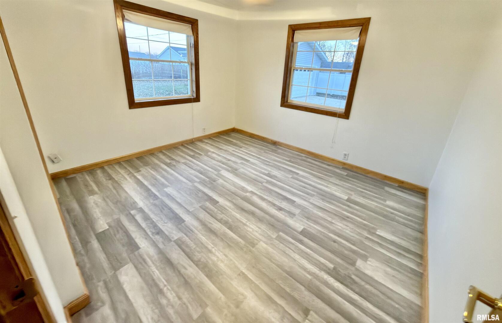 274 Oaktree Avenue Salem, IL 62881 - Photo 24 of 45 a view of an empty room with wooden floor and a window