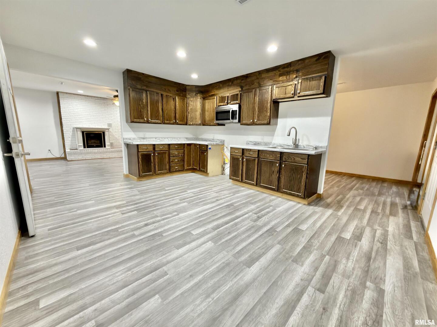 274 Oaktree Avenue Salem, IL 62881 - Photo 9 of 44 a large kitchen with stainless steel appliances wooden floor and wooden cabinets