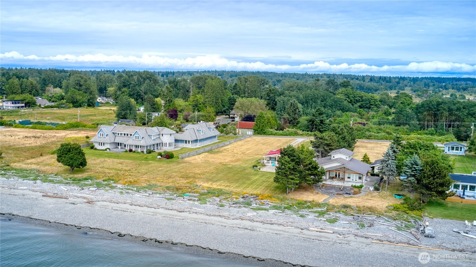 585 Marine Drive Point Roberts, WA 98281 - Photo 11 of 21 a view of a swimming pool with an outdoor seating and a garden