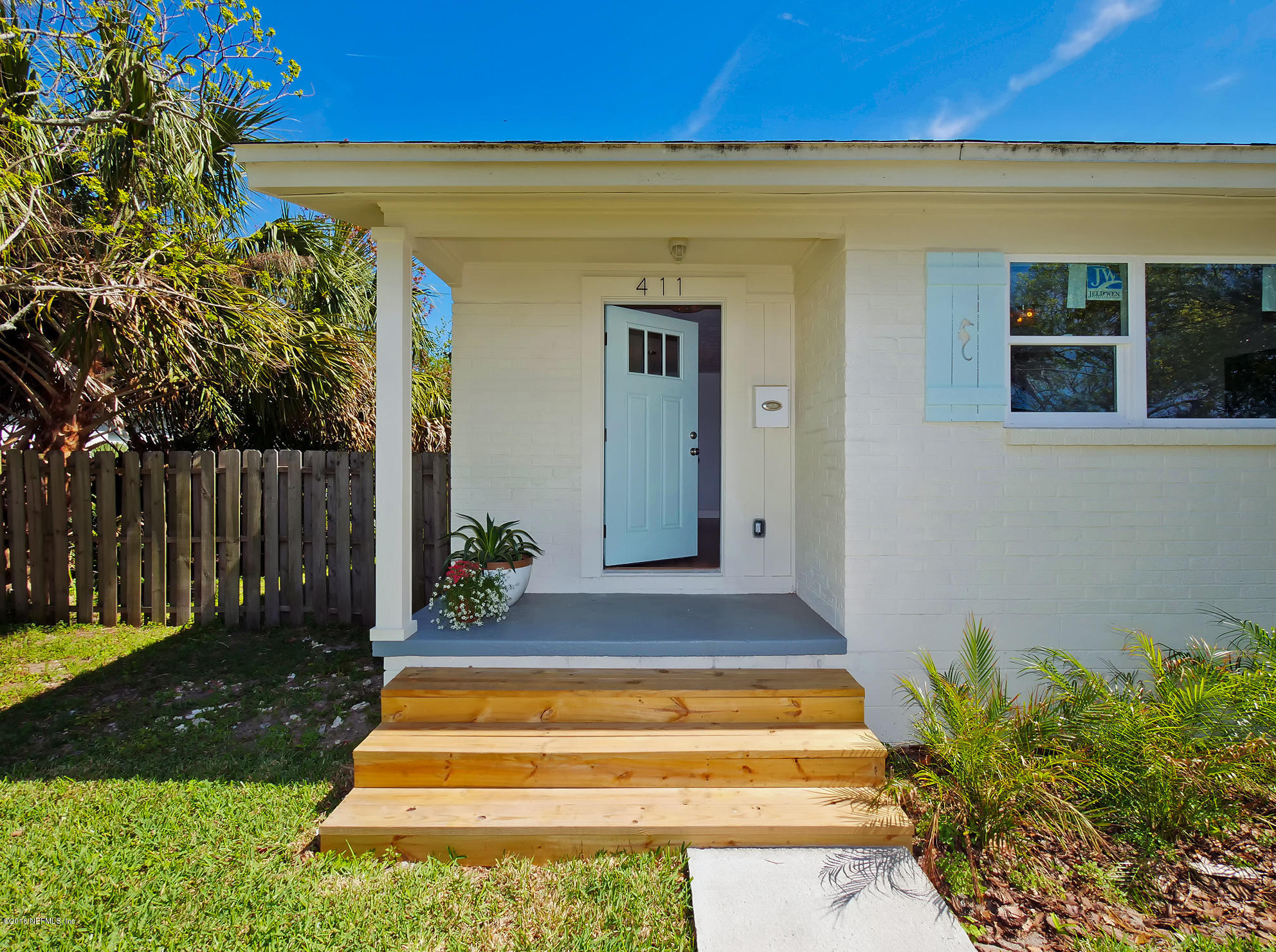 411 Skate Road Atlantic Beach, FL 32233 - Photo 1 of 26 a front view of a house with garden
