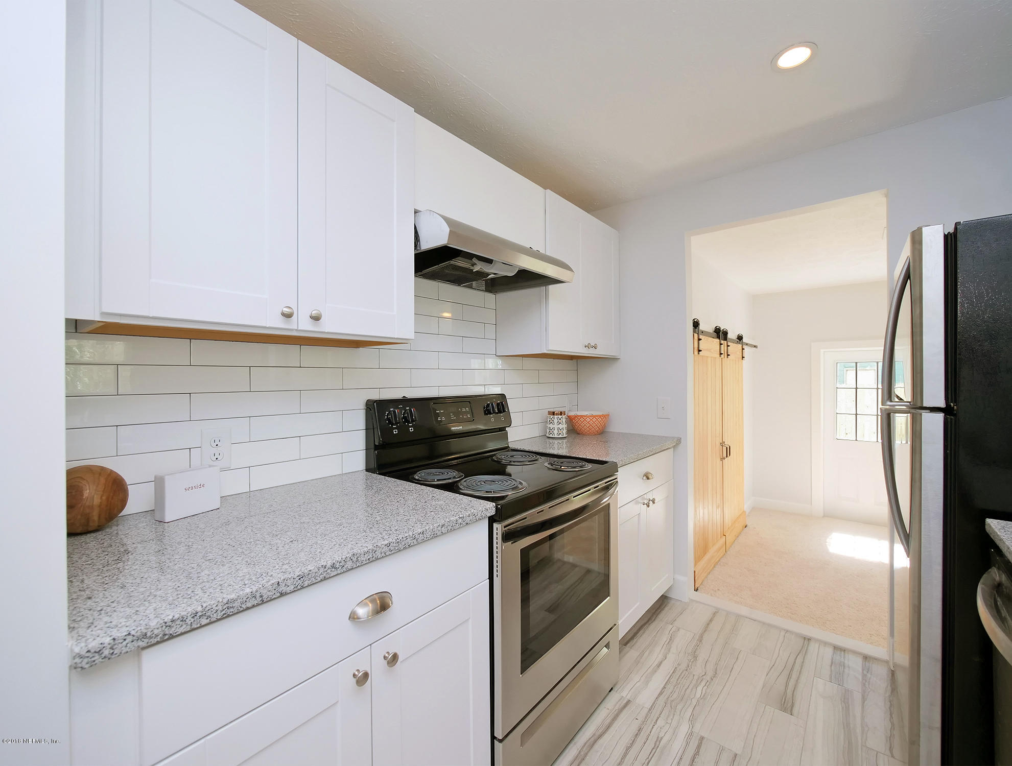 411 Skate Road Atlantic Beach, FL 32233 - Photo 10 of 26 a kitchen with a sink stainless steel appliances and cabinets