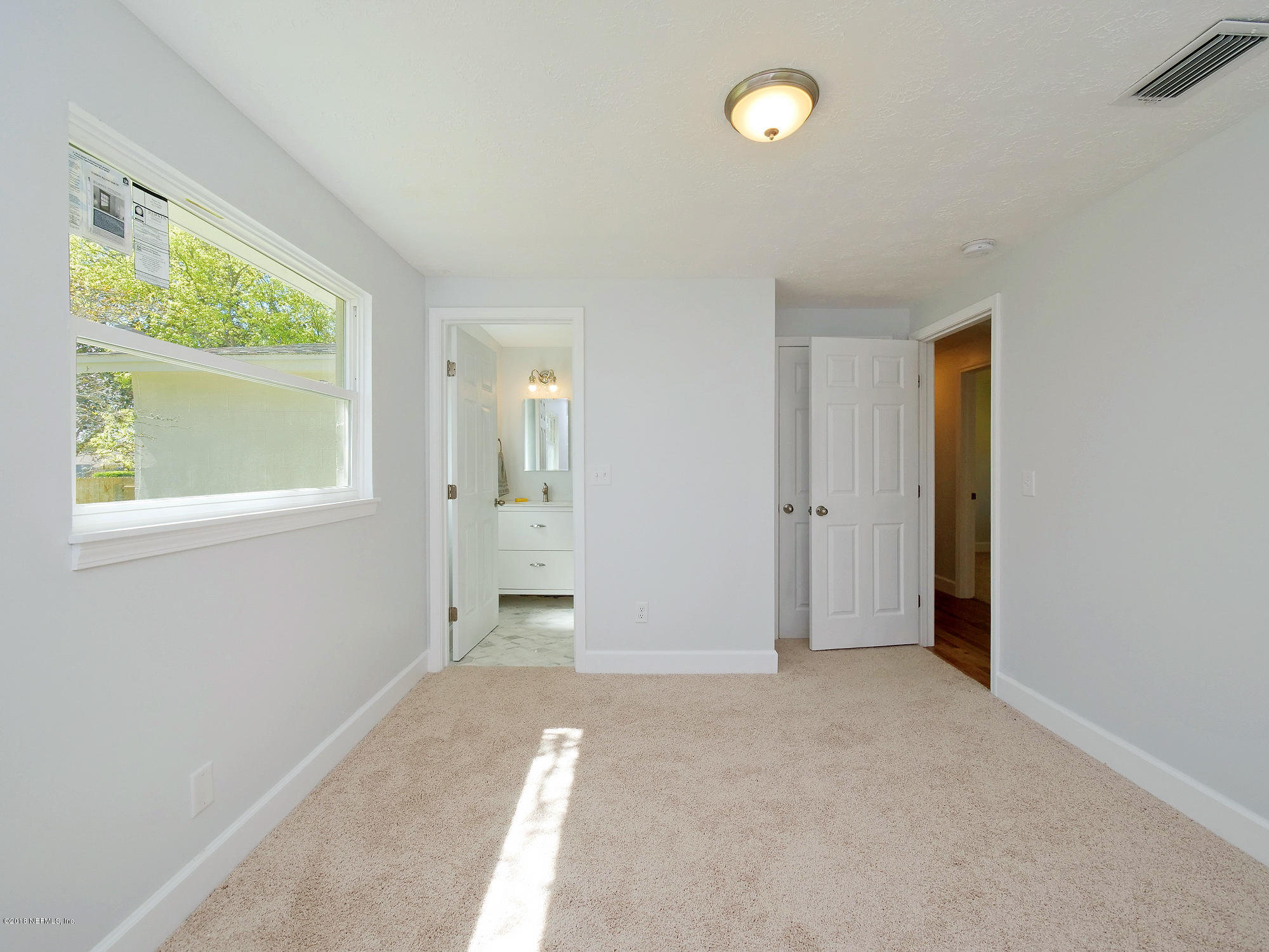 411 Skate Road Atlantic Beach, FL 32233 - Photo 15 of 26 an empty room with windows and closet